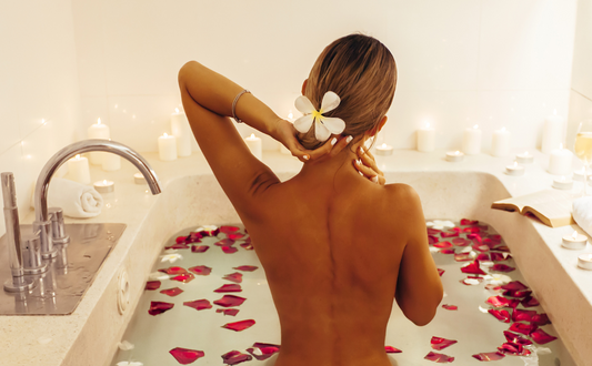 Woman relaxing in a candlelit home spa bath symbolizing self-care and emotional wellness